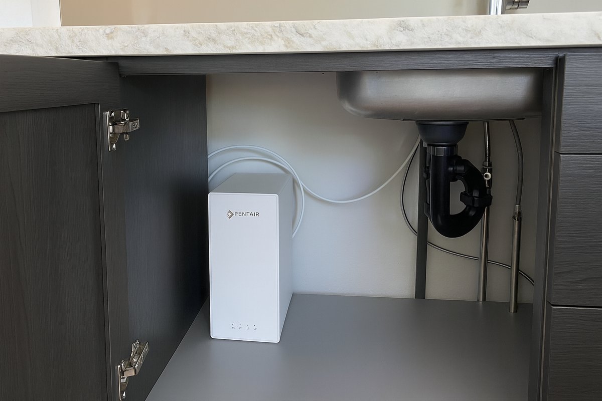 ES60 fitted under the sink in a kitchen with charcoal cabinetry